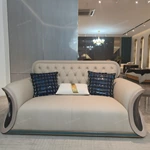 Cream Diamond-Tufted Leather Sofa with Scroll Armrests and Dark High-Gloss Wood Sides